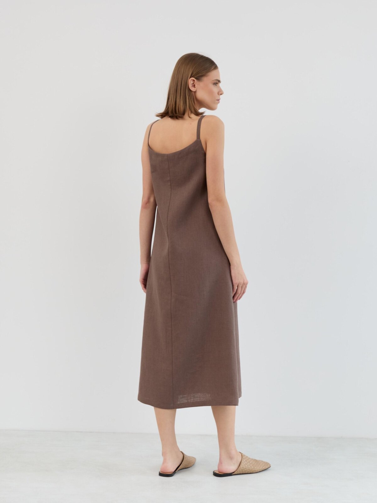 Back view of the AMARA sleeveless linen midi dress in cocoa brown showing the clean back and midi length
